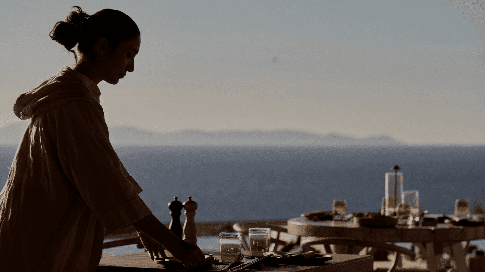 Setting the table at one of the best restaurants in Santorini, carrying the signature of ANDRONIS.