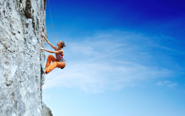 a woman climbing on a rock